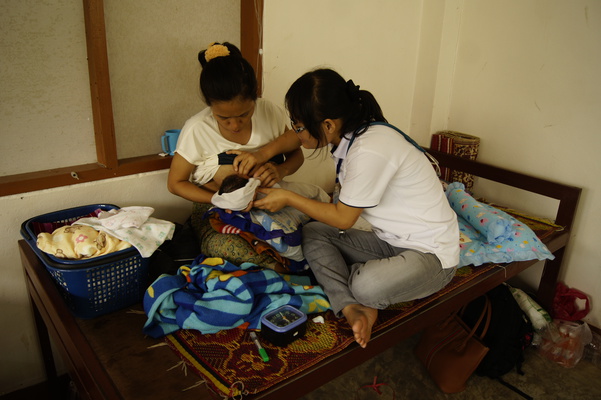 Nurse helping with the breastfeeding for a newborn baby